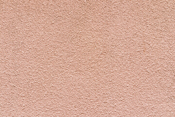 Beautiful embossed beige surface. Abstract background of painted wall surface. An example of a rough texture. A copy of the space.