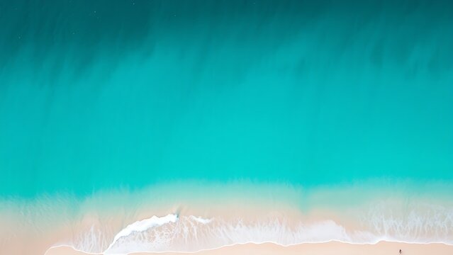 Aerial view of turquoise coastal waters with white sand, capturing the beauty of a tropical paradise.