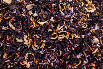A tea blend of dry traditional tea leaves and petals, blue cornflower flowers. bright taste. organic drink. protection of the body, selective focus.