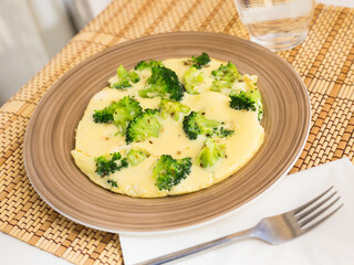 wholesome breakfast. omelet with broccoli on brown plate