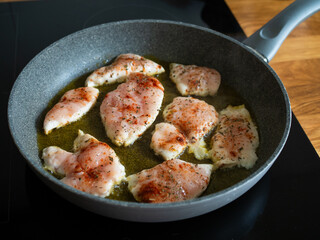 Frying chicken cutlets in frying pan, close-up	