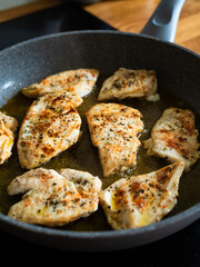 Frying chicken cutlets in frying pan, close-up	