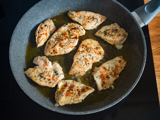 Frying chicken cutlets in frying pan, close-up	
