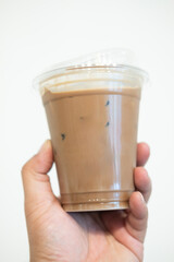 Iced mocha coffee close up on hand