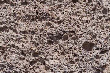 Porous volcanic stone texture, detailed close-up of natural rock surface with cavities. Perfect geology background for scientific, educational, construction or abstract design use