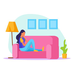 Young woman relaxing on a comfortable couch with a tablet, enjoying leisure time indoors