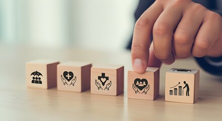 Person selecting wooden cubes with icons of health, life, and financial insurance protection options
