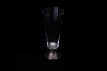 Clear Glass with Metal Base on Black Background