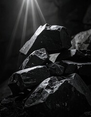 Sunlit stones, a precarious stack of dark rocks, dramatic lighting