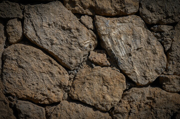 Old rustic beige stone masonry wall background