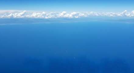 Tranquil seascape featuring calm ocean waves and vibrant blue sky at horizon line