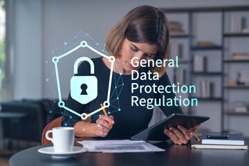 Woman studying GDPR compliance with digital lock icon and text overlay in modern office background, symbolizing data protection concept.