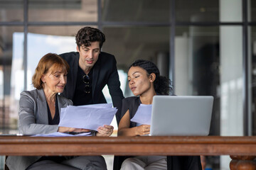 Group of managers or business workers share heir happiness after achieving project target. A moment of team's collective efforts in business workplace shared by members from different generations