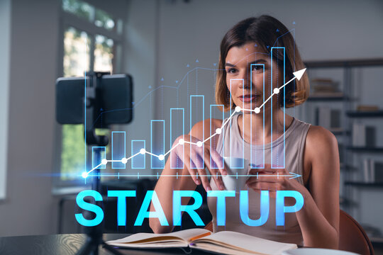 Woman working on startup project with growth chart overlay in modern indoor background concept for entrepreneurship and innovation success.