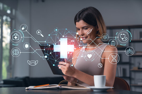 Woman using digital tablet with futuristic healthcare interface graphics in modern indoor setting, representing health technology concept..
