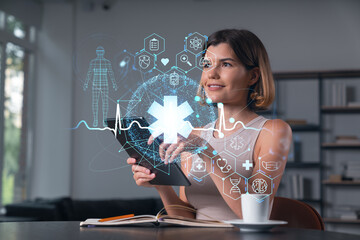 Woman using digital tablet with futuristic medical interface icons and holograms on modern office background, representing innovation in healthcare concept.