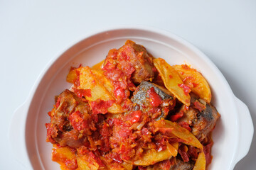 Indonesian homemade food tongkol balado. Fried tuna fish and potato with spicy red chili sambal