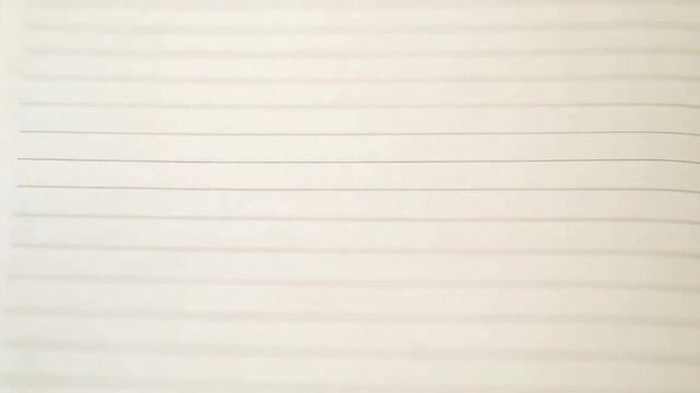 A close-up shot of a sheet of paper with lines and grid pattern, suitable for graphic design or education use