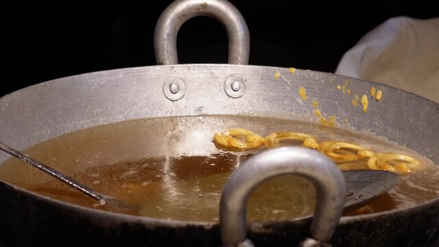 Jalebi sinks in sugar syrup primarily because the syrup is denser than the fried jalebi