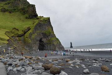 A rock by the coast where a flock of puffins reside