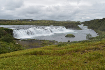 Waterfall on the river in cloudy weather, nature and landscape
