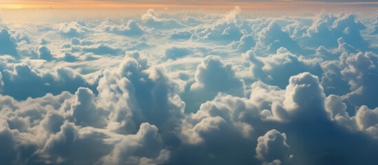 cinematic dramatic surreal cloudy sky, wispy fluffy clouds, glowing sunlight rays, vibrant blue and orange tones, hazy atmospheric lighting, wide aerial landscape, mystical dreamlike environment, high