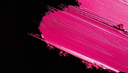 A vibrant fuchsia pink lipstick smear with a creamy texture is artfully smudged across a stark black background.