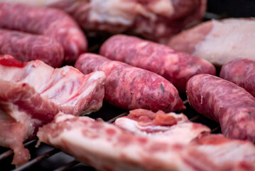 Raw Sausages and Pork on a Barbecue Grill The Concept of a Summer BBQ