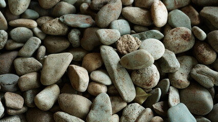 small pebbles or small river stones, arranged in front of the house, usually for foot therapy, white, brown and black in color