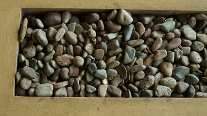 small pebbles or small river stones, arranged in front of the house, usually for foot therapy, white, brown and black in color