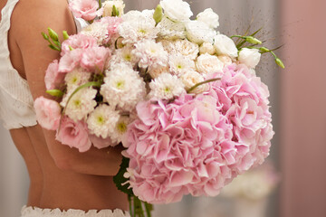 female hands holding bouquet flowers. Gift on the 8 march or valentines day. pink hydrangea
