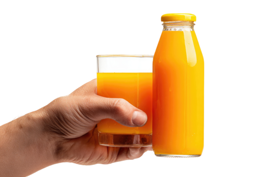 Hand holding a glass of orange juice next to a bottle of orange juice