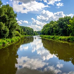 Obraz premium Serene river scene reflecting clouds and lush green banks
