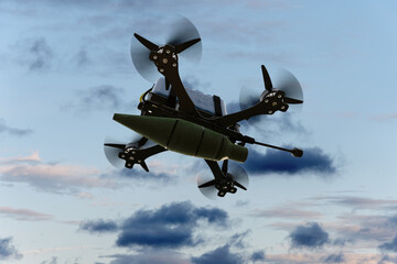 Kamikaze combat FPV drone with a suspended bomb on the background of the evening sky.