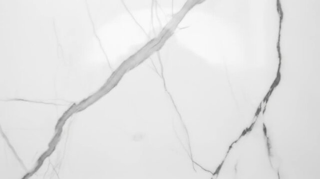 Elegant white marble surface with subtle gray veining, ideal for backgrounds in design and architecture