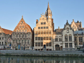 Graslei and Korenlei Waterfront at Sunset - Historic guild houses lining the Graslei and Korenlei canals, with people enjoying the sunset at a vibrant waterfront in Ghent, Belgium.