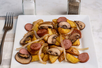 potatoe wedges  with mushromms, kielbasa and onions
