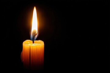 Bright Flame of a Single Candle with Dark Background for Serenity