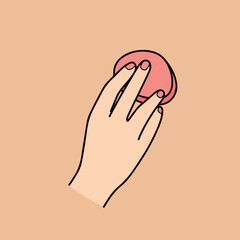 Hand holding a round pink sponge with black outline on beige backdrop