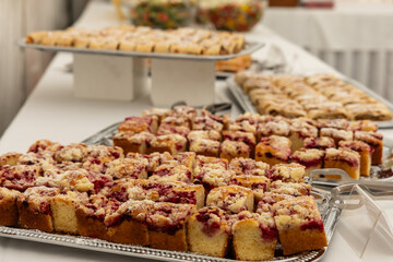 Baked cake sliced ​​on a tray for public catering