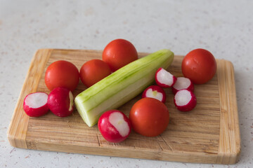 Vegetable garnish in the kitchen. Cucumber, radish, tomato, bell pepper