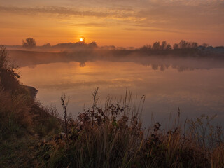 Fototapeta premium Misty sunrise over the river with fog 