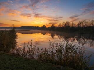 amazing October sunrise over the river with fog 