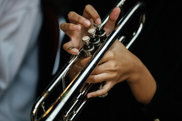 Close Up of Musician Playing Silver Trumpet on rehearsal studio 
