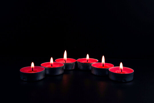 red candles on black background