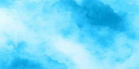 A fluffy white cumulus cloud floats in a bright blue sky on a clear summer day