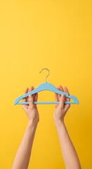 Person Holding a Blue Hanger.