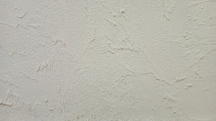 Rough beige cement wall texture background with natural light