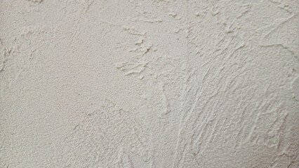 Rough beige cement wall texture background with natural light