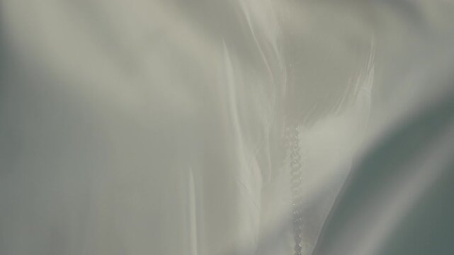 Woman, sheer, fabric behind translucent cloth, ethereal movement, soft light, abstract texture
